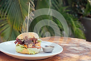 Prawns burger and french fry on table tropical sea ,palms tree and beach background