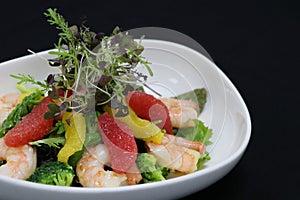 Prawns and citrus frfuits salad in a serving bowl