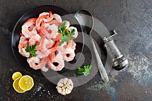 Prawns on plate. Shrimps, prawns. Seafood. Top view. Dark background