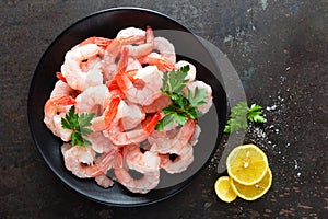 Prawns on plate. Shrimps, prawns. Seafood. Top view. Dark background