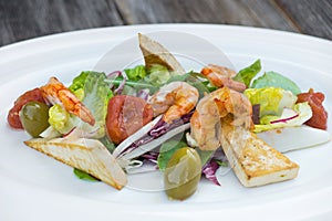 Prawns salad on a wooden background