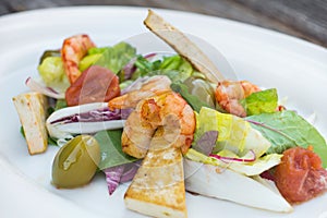 Prawns salad on a wooden background