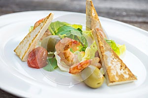 Prawns salad on a wooden background