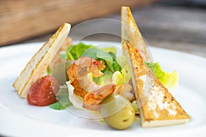 Prawns salad on a wooden background