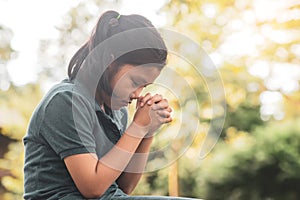 Pray concept.Asian child praying,hope for peace