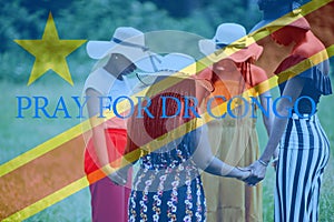 Pray for Democratic Republic of the Congo. Group of four african women holding hands and praying. Concept of crisis in Africa