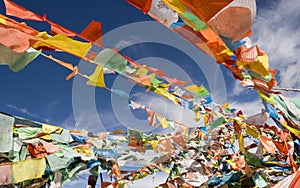 Pray flags weaving against blue sky