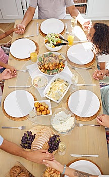 Pray, food and family friends dinner at a table with gratitude, love and religion faith before eating. Praying at a meal