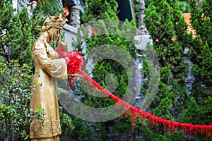 Pray for Good Love with red silk rope at Wong Tai Sin Temple in Hongkong. statue of the bride