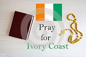 Pray for Ivory Coast. Rosary and Holy Bible background