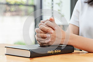 Pray and religion concept, Female christian hands folded on holy bible to prayer for spirituality