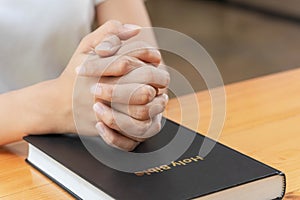 Pray and religion concept, Female christian hands folded on holy bible to prayer for spirituality