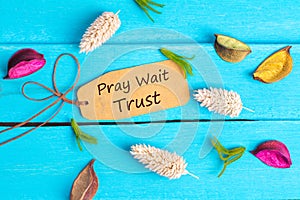 Pray wait trust text on paper tag photo