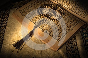 Prayer beads on Koran holy book of Muslims photo
