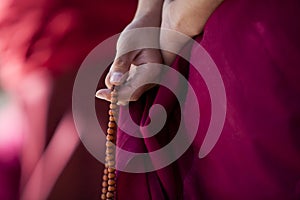 Prayer beads in monk's hand