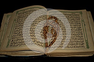 prayer beads and the old holy qur'an.