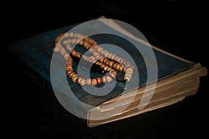 prayer beads and the old holy qur'an.