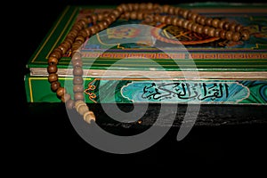 prayer beads and the old holy qur'an.