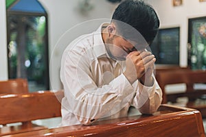 Prayer and bible concept. Asian senior male praying for hope  peace and Hand in hand together, believes and faith in christian rel
