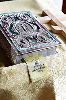 Prayer bible and wooden cross on table in Church