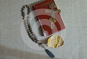 Prayer book, orthodox crucifix and rosary on the table