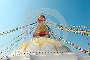 Prayer buddhist flags fluttering in the wind on the Boudhanath stupa in Kathmandu, Nepal