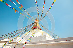 Prayer buddhist flags fluttering in the wind on the Boudhanath stupa in Kathmandu, Nepal