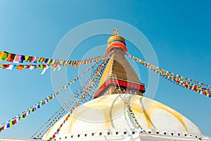 Prayer buddhist flags fluttering in the wind on the Boudhanath stupa in Kathmandu, Nepal