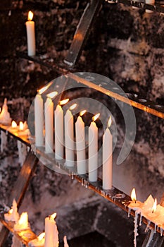 Prayer burning candles as a symbol of hope