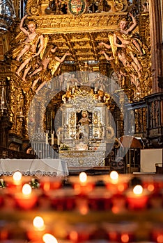 Prayer candles and the ornate interior of Cathedral de Santiago de Compostela