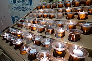 Prayer candles in votives, and insence, inside of a Catholic church