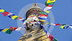 Prayer colorful flags flying from the Buddhist Stupa, a place of holy worship. Temple in the Kathmandu valley, Nepal