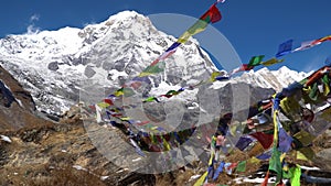 Prayer flags on Annapurna Basecamp, Nepal. Annapurna peak in the Himalaya range, Nepal. Annapurna base camp trek.