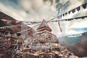 Prayer flags and buddhist stupa on trekking route