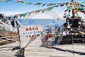 Prayer flags and stupa at the peak of Shika Snow Mountain or Blue Moon Valley in Zhongdian city Shangri-La. Yunnan, China. Asia