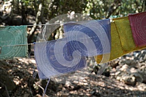 Prayer flags with word "shalom" written on them in Hebrew with the blurred background in Israel