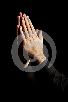 Prayer, hands and black background for hope, religion and faith or ask for help with worship or spiritual support in