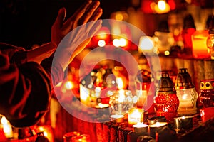 prayer hands. Candles in the cemetery. 1st November. Feast of All Saints. Hallowmas. All Souls& x27; Day.