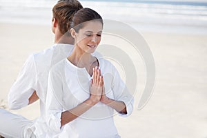 Prayer hands, couple and meditation on beach for zen and wellness with holistic healing outdoor for calm and yoga. Ocean