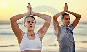 Prayer hands, yoga meditation and couple at beach outdoors for health and wellness. Sunset, pilates fitness and man and