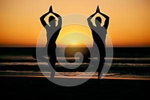 Prayer hands, yoga silhouette and meditation with couple at beach for health or wellness. Sunset, pilates shadow and man