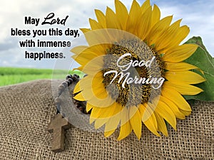 Prayer inspirational words - May Lord bless you this day, with immense happiness. Morning prayer quote with rosary and sunflower. photo
