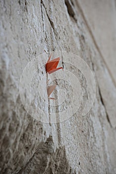 Prayer notes in the shape of origami cranes inserted in the Western Wall in Jerusalem, Israel