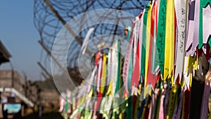 Prayer ribbons attached to a barb wire fence at the Korean Demilitarized Zone