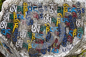 Prayer stones as a form of prayer in Tibetan Buddhism, on hill in Himalaya mountains. Mcleod Ganj, Dharamsala, India.