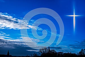 Glowing cross . Christian cross against the sky photo