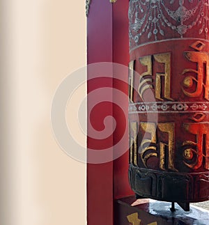 Prayer wheel with bell with language of TIbet named Tibetan, A cylindrical wheel, mantra Om Mani Padme Hum , Vertical image with