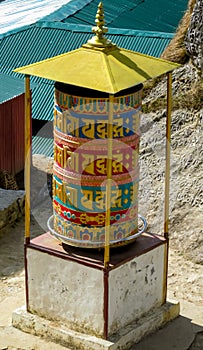 Prayer wheel in Nepali near the Buddhist temple