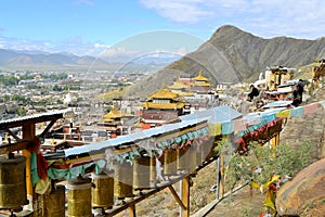 Prayer wheels around monastery in Shigatse, Tibet photo