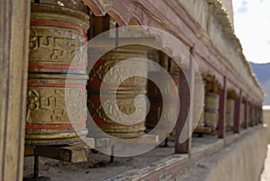 Prayer wheels aside Wanla Gompa, Ladakh photo